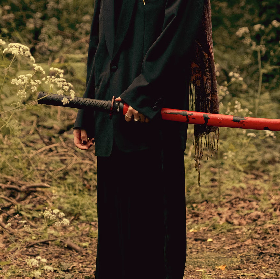 a closeup shot of a woman holding a sword