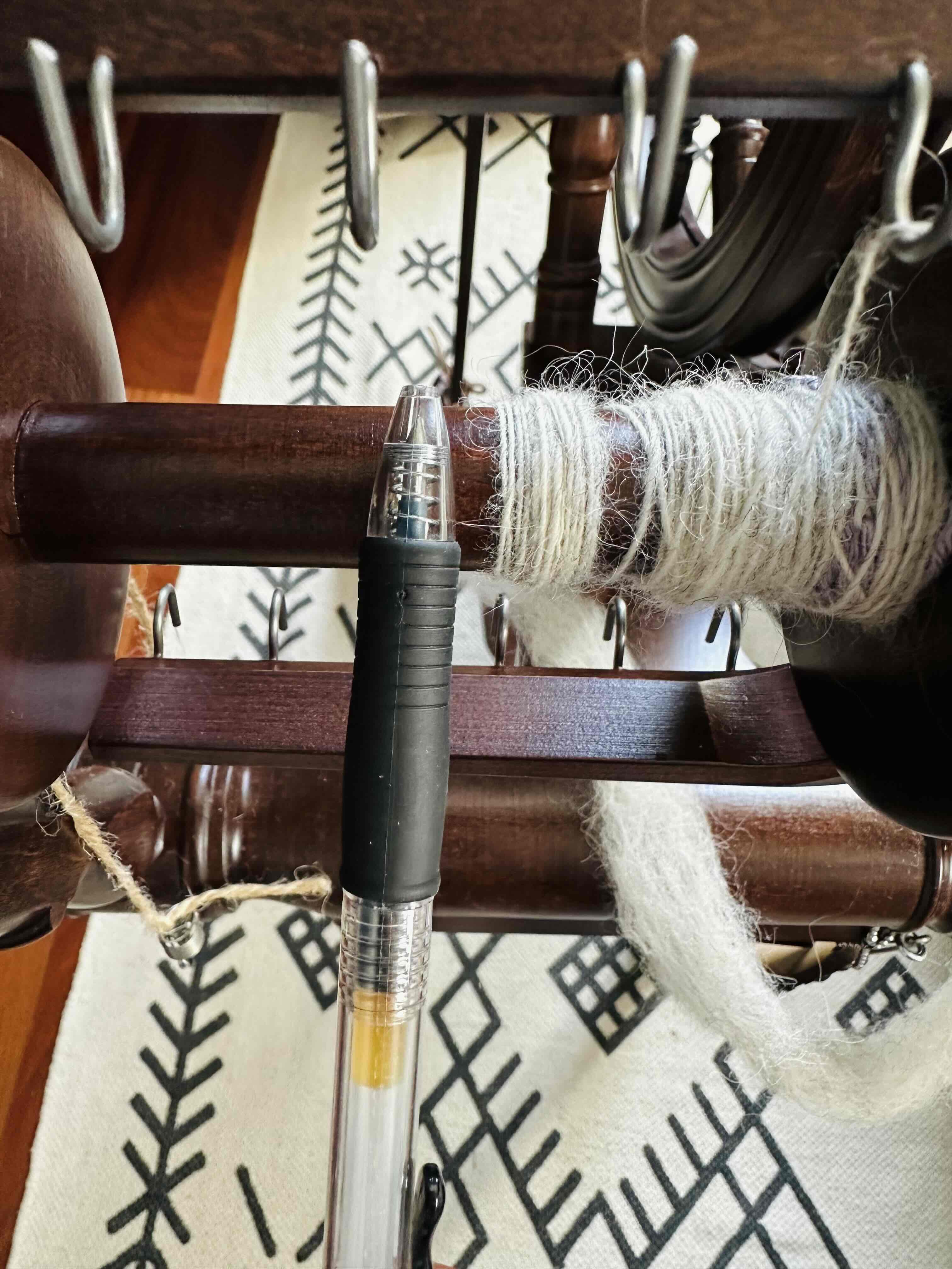 A comparison of a spun single next to a ballpoint pen for scale.